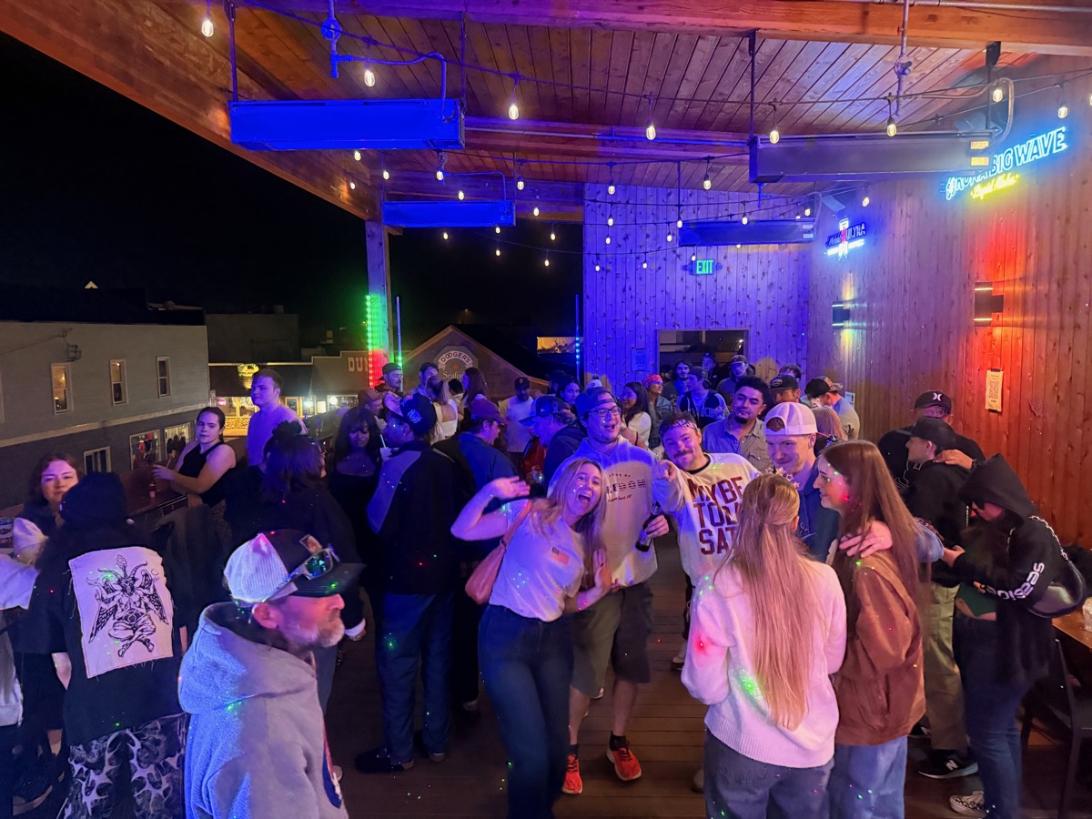 Packed dance floor upstairs at Iggy's — lasers and neon
